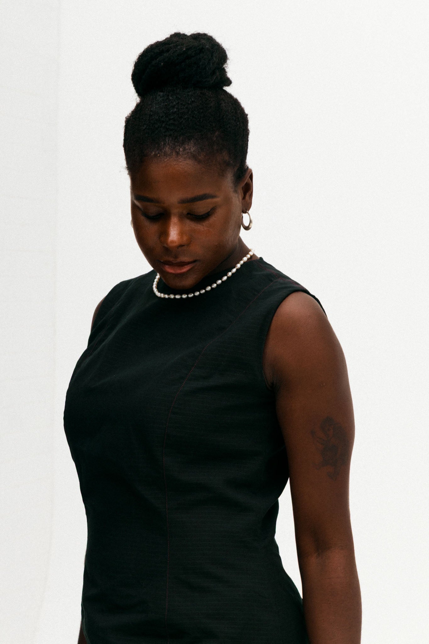 Woman wearing a black dress against a white background
